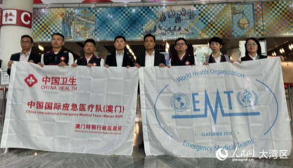 图为中国国际应急医疗队（澳门）成员与罗奕龙等合影。人民网记者 富子梅摄