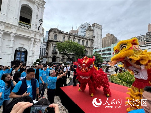 图为岑浩辉在议事亭前地与舞狮队互动。人民网记者 富子梅摄